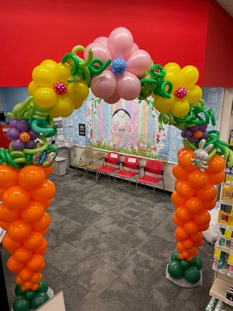 Easter flower and carrot balloon arch installation