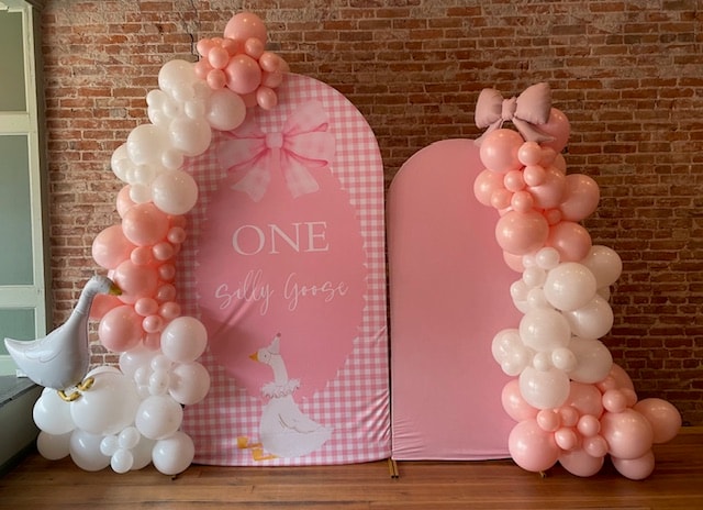 Sally Goose first birthday balloon arch with goose foil