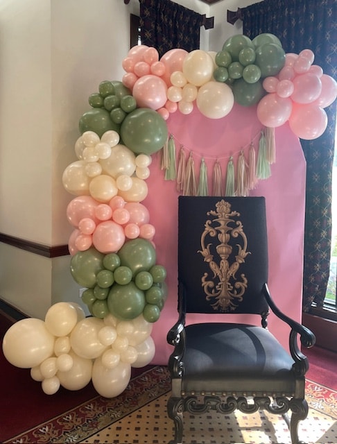 Pink and sage balloon garland with ornate chair
